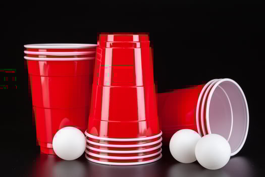 Red plastic cups and ball for game of beer pong photo