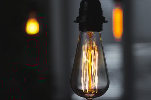 A classic Edison light bulb on dark background with space for text photo