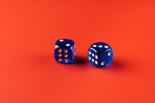 Blue dice on red background close up photo