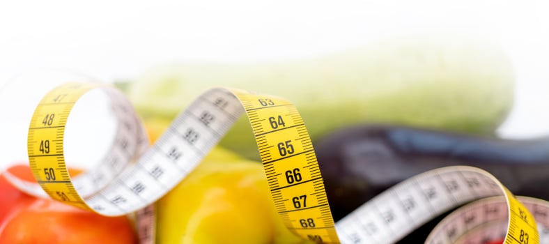 Yellow measuring tape. Fresh vegetables for healthy lifestyle diet food. photo