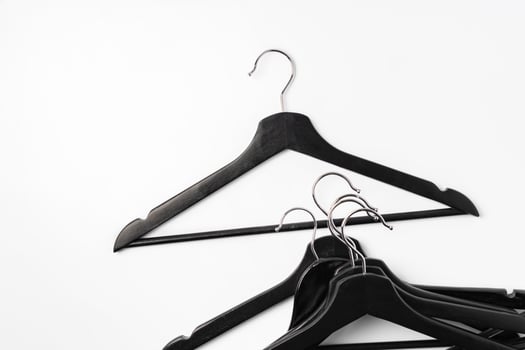 a pile clothes hangers on isolated white background photo