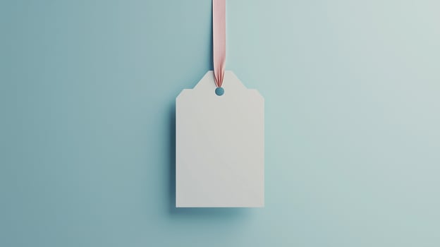 Paper price tag label white brand name with rope on solid blue background photo