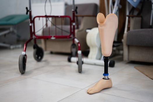 Prosthetic leg in rehabilitation center with walker nearby photo