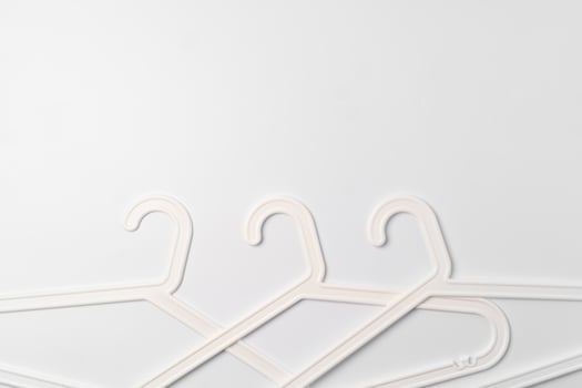 a pile clothes hangers on isolated white background photo