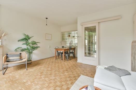 A living room with a wooden floor and white walls photo