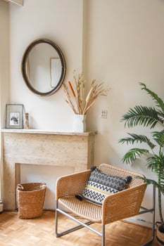 A white wall with a mirror and a chair photo