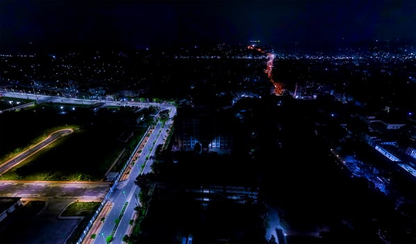 An aerial view of a city at night and the colorful lighting on the road. photo