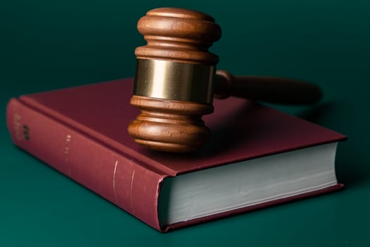 Judge gavel and legal book close up on table photo