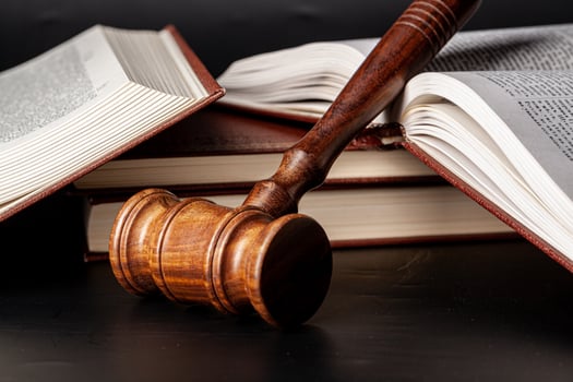 Wooden gavel and juridical books close up photo