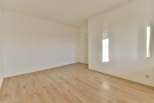 Empty room with white walls and wooden floors photo