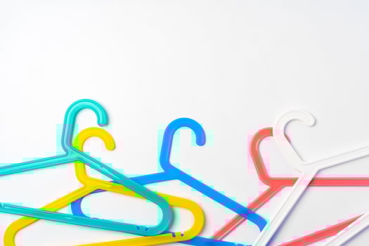 a pile clothes hangers on isolated white background photo
