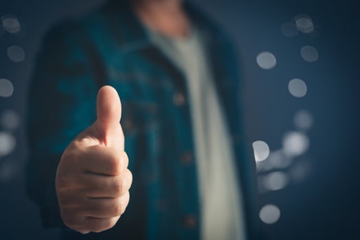Portrait of a businessman in a casual wear standing thumbs up, half body and not showing face. photo