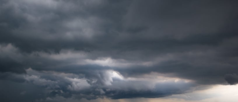 Bad or moody weather sky and environment. the dark sky with heavy clouds converging and a violent storm before the rain. carbon dioxide emissions, greenhouse effect, global warming, climate change. photo