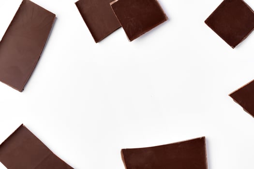 Piece of dark chocolate isolated on white background photo