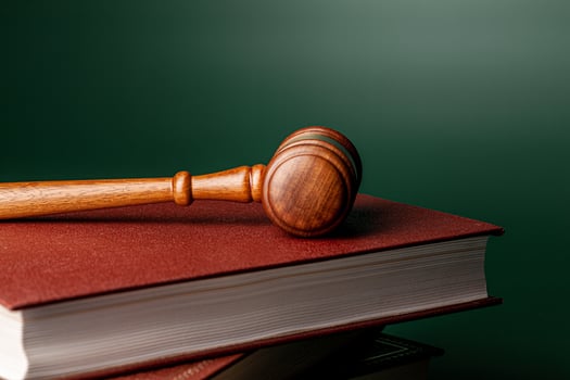 Close up of a brown wooden gavel and book photo