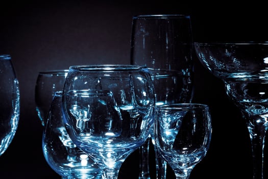Empty glasses for drinks on dark background photo