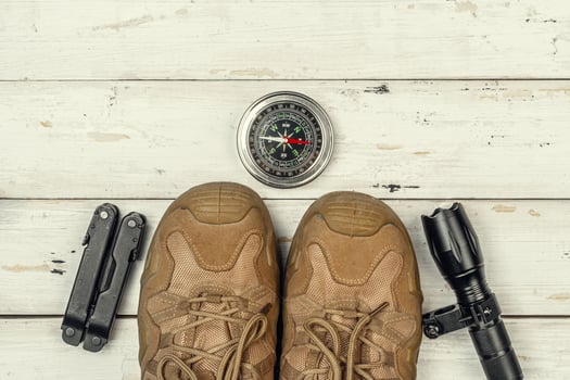 Hiking boots, compass and knife. Hiking outdoor equipment photo