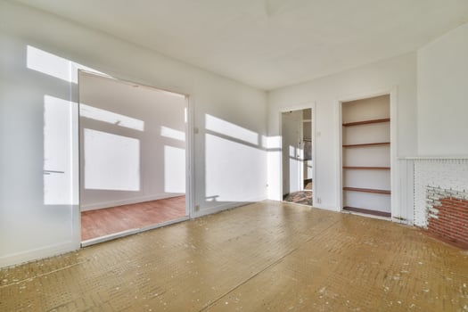 An empty room with a fireplace and wooden floors photo