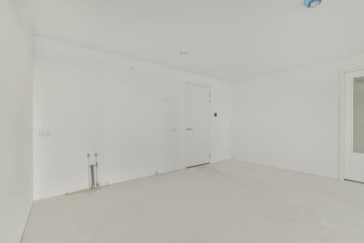 An empty room with white walls and a door photo