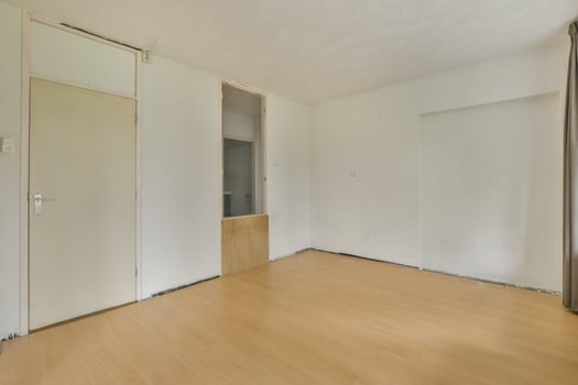 An empty room with wooden floors and a door photo