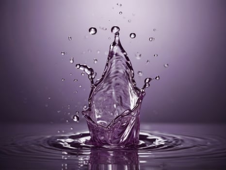A splash of water on a purple background. photo