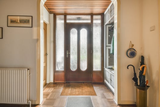 A hallway with a door and a radiator photo