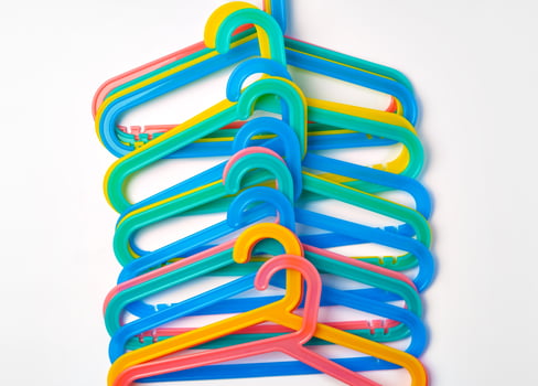 a pile clothes hangers on isolated white background photo