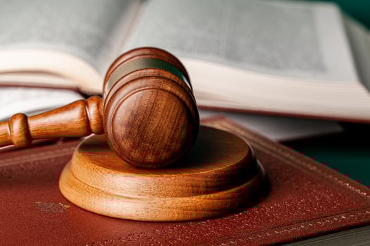 Close up of a brown wooden gavel and book photo