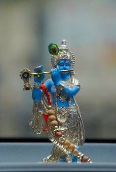 Colorful figure of the Hindu God Krishna playing the flute portrait image photo