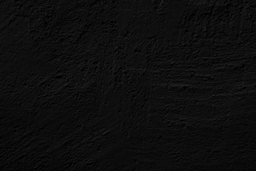 Black rough stucco. Texture of wall of house. Abstract black background. photo