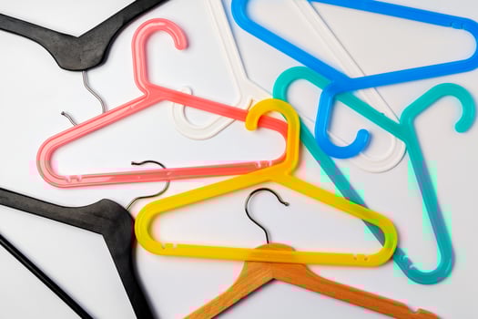 a pile clothes hangers on isolated white background photo