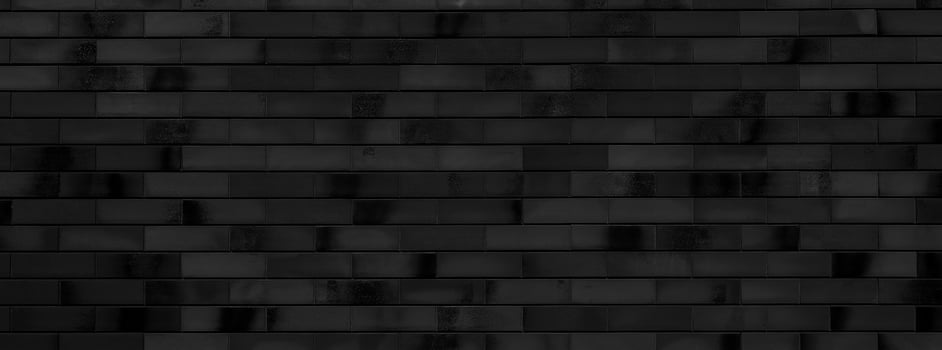 Black brick wall of building. Brick texture. Architectural abstract black background. photo