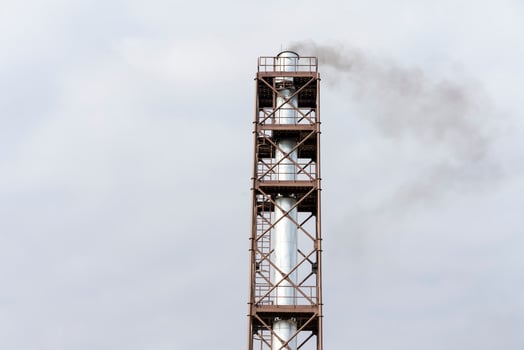 Industrial view of high metal pipe with dark smoke. Environmental problems. Environmental pollution photo