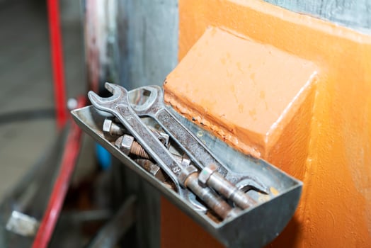 Old tools for men's work. Hammer and wrenches. Hang neatly in the box. Working old tools for repairing devices at the enterprise photo