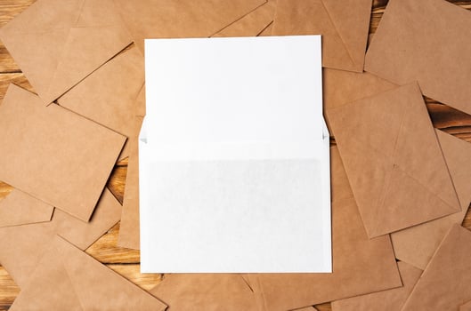 Stack of envelopes on working desk top view. Business mail photo