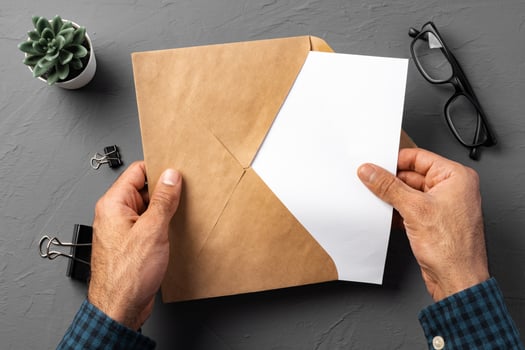 Business correspondence. Top view of man hands holding mockup envelope with letter. Copy space. photo