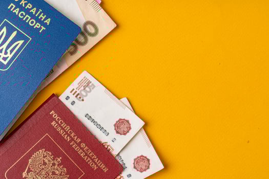 Ukrainian and russian passport with money, russian roubles and ukrainian hryvnia photo