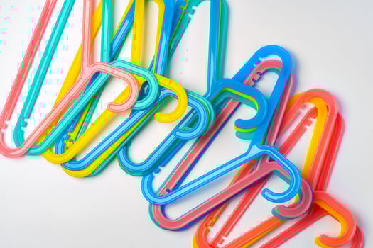 a pile clothes hangers on isolated white background photo