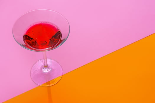 Glass of fresh cocktail on color background photo