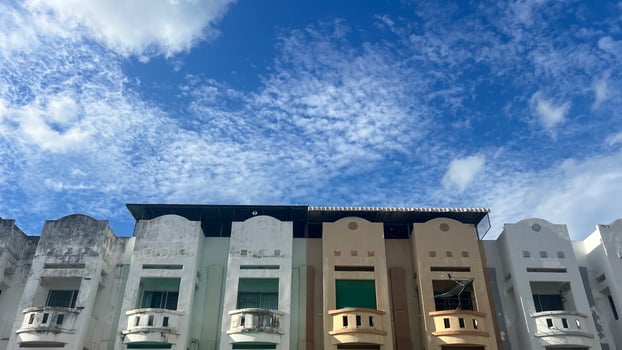 Old town buildings under a vibrant blue sky with clouds. Perfect for architecture and urban photography themes photo