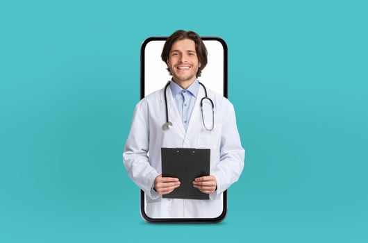 A young doctor delivers a virtual healthcare consultation, depicted within the blank screen of a smartphone, in a sleek medical environment. photo