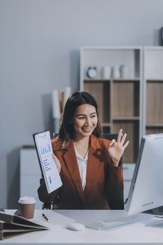 Business woman work process concept. Young woman working university project with generic design laptop. Happy excited woman at home workstation. Blurred background. photo
