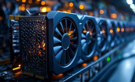 A row of computer fans are lit up in a dark room. The fans are black and have a metallic appearance photo