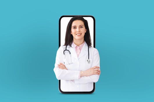 Woman doctor wearing a white coat and stethoscope is conducting a virtual consultation. The telemedicine technology, with her appearing through a smartphone screen against a blue background. photo