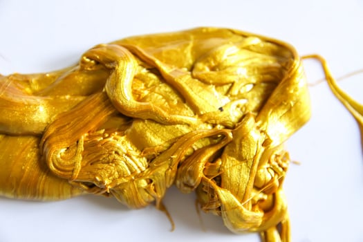 Gold slime on white background photo