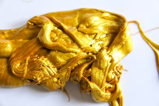 Gold slime on white background photo