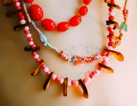 Handmade bright beads on a child's body in sunlight. photo