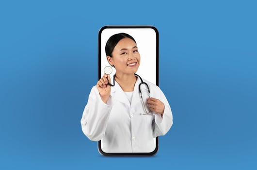 This image shows a young asian woman doctor on a smartphone screen, delivering innovative telehealth services from a neat, professional office. photo