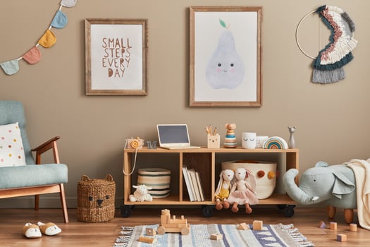 Stylish scandinavian kid room with toys, teddy bear, plush animal toys, mint armchair, furniture, decoration and child accessories. Brown wooden mock up poster frames on the wall photo