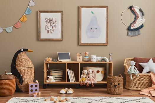 Stylish scandinavian kid room interior with toys, teddy bear, plush animal toys, sofa, furniture, decoration and child accessories. Brown wooden mock up poster frames on the wall. photo